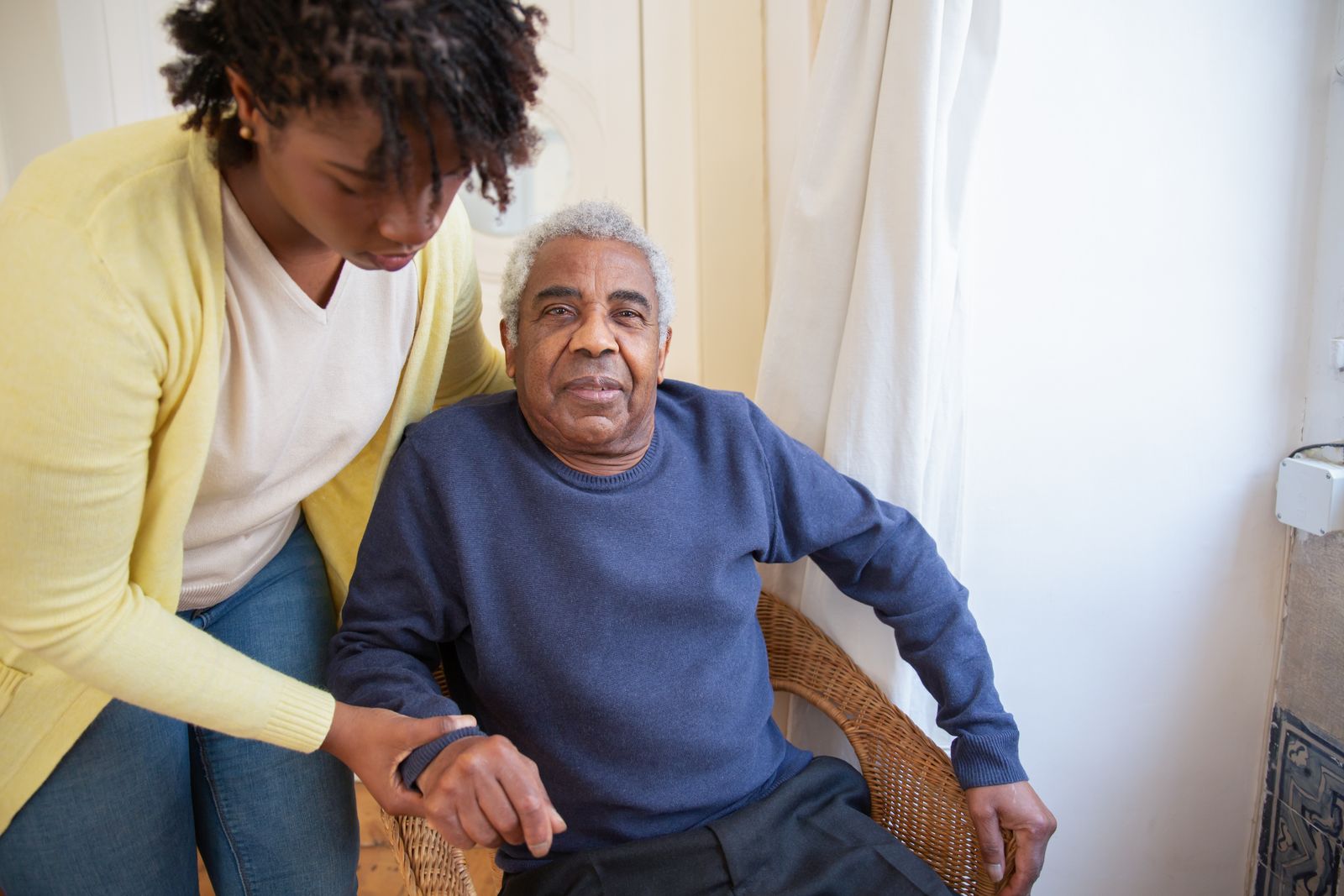 Care professional supporting an older adult at home
